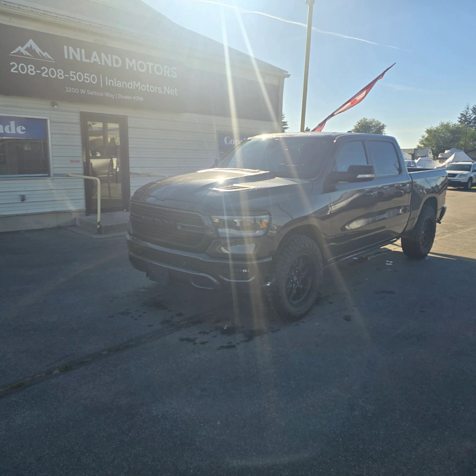Gray Ram pickup parked at Inland Motors